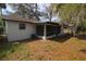A white house with a screened patio in the backyard, ideal for outdoor enjoyment and relaxation at 349 Fletcher Ave, Daytona Beach, FL 32114