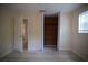 A bedroom featuring wood floors, open door and a closet with bi-fold doors and wood paneling at 349 Fletcher Ave, Daytona Beach, FL 32114