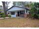 Charming home with a welcoming porch, set amidst a lush, green landscape at 349 Fletcher Ave, Daytona Beach, FL 32114