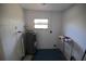 Utility room with hot water heater, white walls, and concrete floor at 349 Fletcher Ave, Daytona Beach, FL 32114