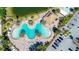 Aerial view of resort style pool with chairs and tropical trees at 3611 Marisol Ct, New Smyrna Beach, FL 32168