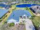 Stunning aerial view of the home showcasing its well-maintained landscaping, lakeside views, and charming curb appeal at 3611 Marisol Ct, New Smyrna Beach, FL 32168