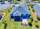 Aerial view showcasing backyard with screened lanai and patio with beautiful landscaping and lush lawn at 3611 Marisol Ct, New Smyrna Beach, FL 32168