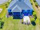 A high-angle aerial view of the home with a screened-in porch and an outdoor patio with chairs at 3611 Marisol Ct, New Smyrna Beach, FL 32168