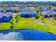 Aerial view of the home showcasing the backyard, mature trees, and proximity to the lake at 3611 Marisol Ct, New Smyrna Beach, FL 32168