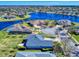 Aerial view of homes surrounding a lake featuring pristine landscaping and community features at 3611 Marisol Ct, New Smyrna Beach, FL 32168