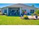 A beautiful screened porch overlooks the home's backyard and lush green lawn at 3611 Marisol Ct, New Smyrna Beach, FL 32168