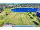 Aerial view of an expansive backyard with lush green grass and views of the serene lake at 3611 Marisol Ct, New Smyrna Beach, FL 32168