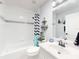 Bathroom featuring a shower-tub combo, single vanity, and black-and-white shower curtain at 3611 Marisol Ct, New Smyrna Beach, FL 32168