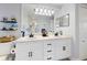 Well-lit bathroom featuring a double vanity, ample counter space, and decorative shelves at 3611 Marisol Ct, New Smyrna Beach, FL 32168