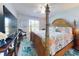Bedroom with a four-poster bed, tropical bedding, and a large window with shutters at 3611 Marisol Ct, New Smyrna Beach, FL 32168