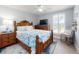 Bright bedroom with a ceiling fan, wood furniture, and large window with plantation shutters at 3611 Marisol Ct, New Smyrna Beach, FL 32168