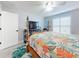 Bright bedroom featuring a four-poster bed, ceiling fan, and large window with plantation shutters at 3611 Marisol Ct, New Smyrna Beach, FL 32168