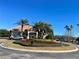 Clubhouse on landscaped traffic circle with tropical trees at 3611 Marisol Ct, New Smyrna Beach, FL 32168