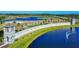 Aerial view of the community entrance with lush landscaping, water features, and a grand gatehouse at 3611 Marisol Ct, New Smyrna Beach, FL 32168