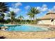 Resort style pool with lounge chairs and tropical trees at 3611 Marisol Ct, New Smyrna Beach, FL 32168
