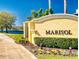 Landscaped entrance sign to Marisol community with colorful flowers and lush greenery at 3611 Marisol Ct, New Smyrna Beach, FL 32168