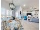 Bright dining area with a round table set for four, overlooking the living room and outdoor views at 3611 Marisol Ct, New Smyrna Beach, FL 32168