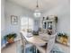 Bright dining room with an oval table set for four, nautical decor, and plenty of natural light at 3611 Marisol Ct, New Smyrna Beach, FL 32168