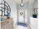 Inviting entryway with decorative mirror, stylish light fixture, and tiled floor at 3611 Marisol Ct, New Smyrna Beach, FL 32168