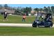 Golf course featuring a golf cart and people playing golf at 3611 Marisol Ct, New Smyrna Beach, FL 32168