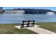 Scenic view of the lake with fountains and a bench in the community at 3611 Marisol Ct, New Smyrna Beach, FL 32168