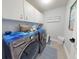 Well-organized laundry room featuring modern appliances and ample storage space at 3611 Marisol Ct, New Smyrna Beach, FL 32168