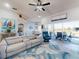 Cozy living room with modern decor, ceiling fan, and view of the lake through sliding glass doors at 3611 Marisol Ct, New Smyrna Beach, FL 32168