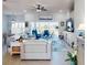 Spacious living room with modern furniture, ceiling fan, and sliding glass doors leading to outdoor space at 3611 Marisol Ct, New Smyrna Beach, FL 32168
