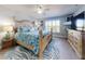 Large primary suite features a ceiling fan and views to the exterior at 3611 Marisol Ct, New Smyrna Beach, FL 32168