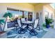 Inviting outdoor patio with seating, a palm tree, and a sliding glass door, perfect for relaxing and entertaining at 3611 Marisol Ct, New Smyrna Beach, FL 32168