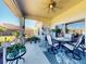 Inviting screened in outdoor patio with seating and lush landscaping surrounding the area at 3611 Marisol Ct, New Smyrna Beach, FL 32168