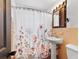 Bathroom featuring a pedestal sink, mirror, and a shower with a decorative floral curtain at 38 Seacrest Dr, Ormond Beach, FL 32176