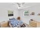 Cozy bedroom featuring a ceiling fan, two windows offering natural light and warm toned furnishings at 38 Seacrest Dr, Ormond Beach, FL 32176