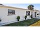 Side view of a well-maintained home, complemented by lush green lawn and manicured plants at 38 Seacrest Dr, Ormond Beach, FL 32176