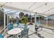 Enclosed patio featuring ample seating, hanging plants, and a bright, airy atmosphere at 38 Seacrest Dr, Ormond Beach, FL 32176