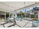 Spacious screened patio with outdoor seating, hanging plants, and a well-lit environment at 38 Seacrest Dr, Ormond Beach, FL 32176