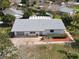 An aerial view of a single Gathering residence with fresh landscaping in a lush residential neighborhood at 403 Wildwood Dr, Edgewater, FL 32132