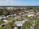 An aerial view of a residential neighborhood featuring well-maintained lawns and diverse home styles near a small airport at 403 Wildwood Dr, Edgewater, FL 32132