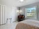 This bedroom includes a desk, bright window, neutral walls, and tiled floors at 403 Wildwood Dr, Edgewater, FL 32132