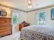 Relaxing bedroom featuring decor, an inviting bed, and two windows offering natural light at 403 Wildwood Dr, Edgewater, FL 32132