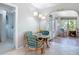 Cozy breakfast nook with a glass-top table, wicker chairs, and view to the sun room at 403 Wildwood Dr, Edgewater, FL 32132