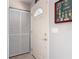 A home's bright entryway featuring a traditional door, adjacent coat closet, and decorative wall art at 403 Wildwood Dr, Edgewater, FL 32132