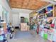 Spacious garage offering ample storage with a wooden ceiling and well-organized shelving at 403 Wildwood Dr, Edgewater, FL 32132