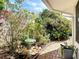Beautiful brick path leads through a verdant garden with vibrant flowering plants and a decorative bird bath at 403 Wildwood Dr, Edgewater, FL 32132