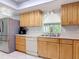 Light and bright kitchen features stainless appliances, breakfast bar and bright countertops at 403 Wildwood Dr, Edgewater, FL 32132