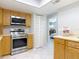 Bright kitchen features stainless steel appliances, light countertops and wooden cabinetry at 403 Wildwood Dr, Edgewater, FL 32132