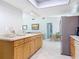 Bright kitchen with stainless steel refrigerator, tiled floors, and wood cabinetry at 403 Wildwood Dr, Edgewater, FL 32132