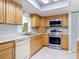 This kitchen features wood cabinets, stainless steel appliances and bright countertops at 403 Wildwood Dr, Edgewater, FL 32132