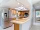 Bright kitchen featuring stainless steel appliances, wood cabinets, and a tile backsplash at 403 Wildwood Dr, Edgewater, FL 32132